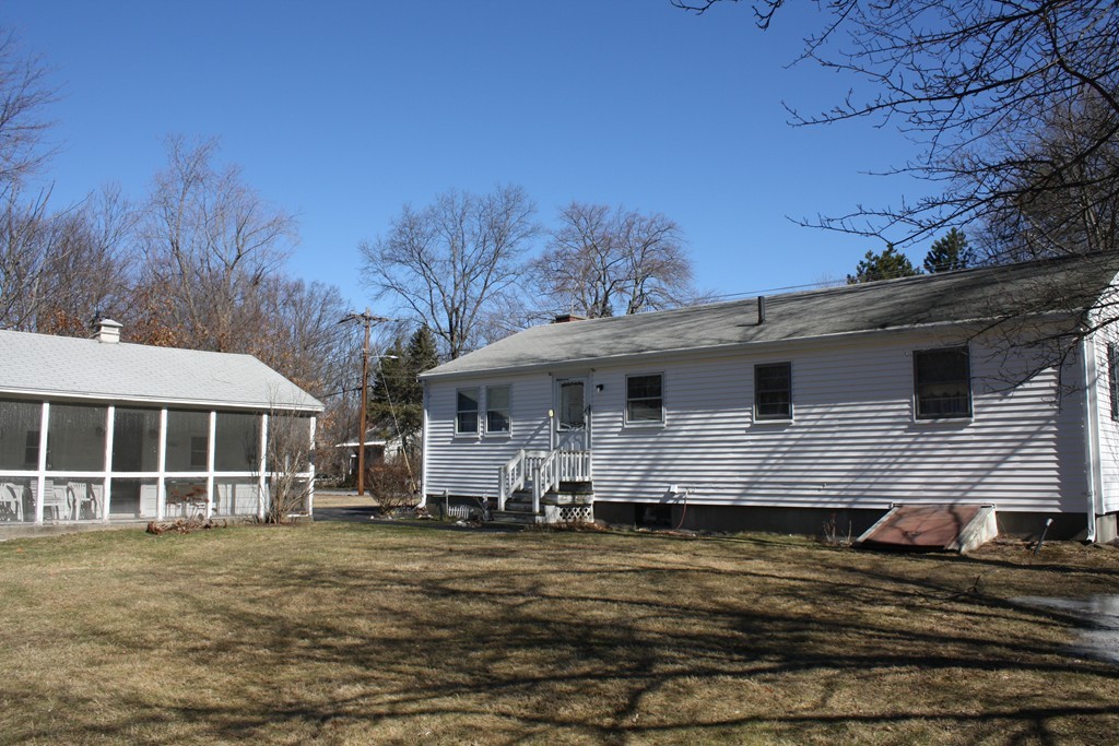 55 Locke Road Chelmsford, MA 01824 - Photo 27 of 28 a front view of a house with a yard