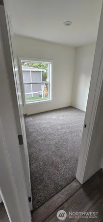 a view of a room with wooden floor