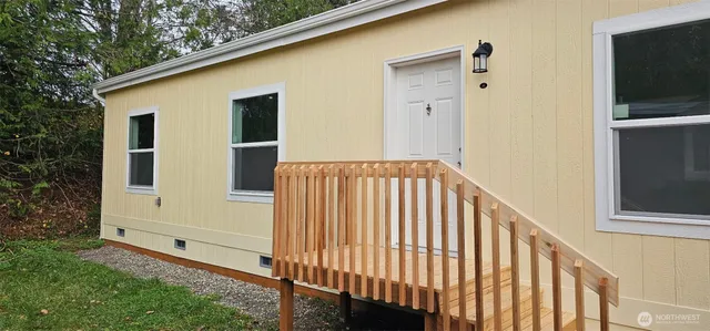 a view of a porch with wooden floor and fence