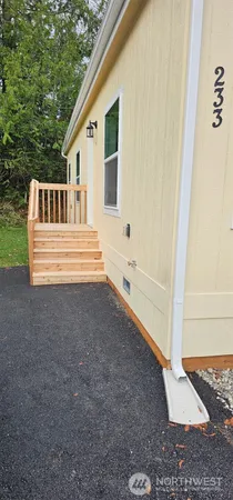 a view of house with backyard and tub
