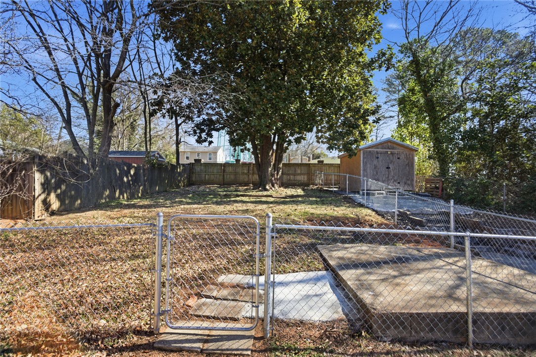 118 North 4th Street Easley, SC 29640 - Photo 12 of 14 This spacious backyard offers ample room for outdoor activities and features a convenient storage shed.