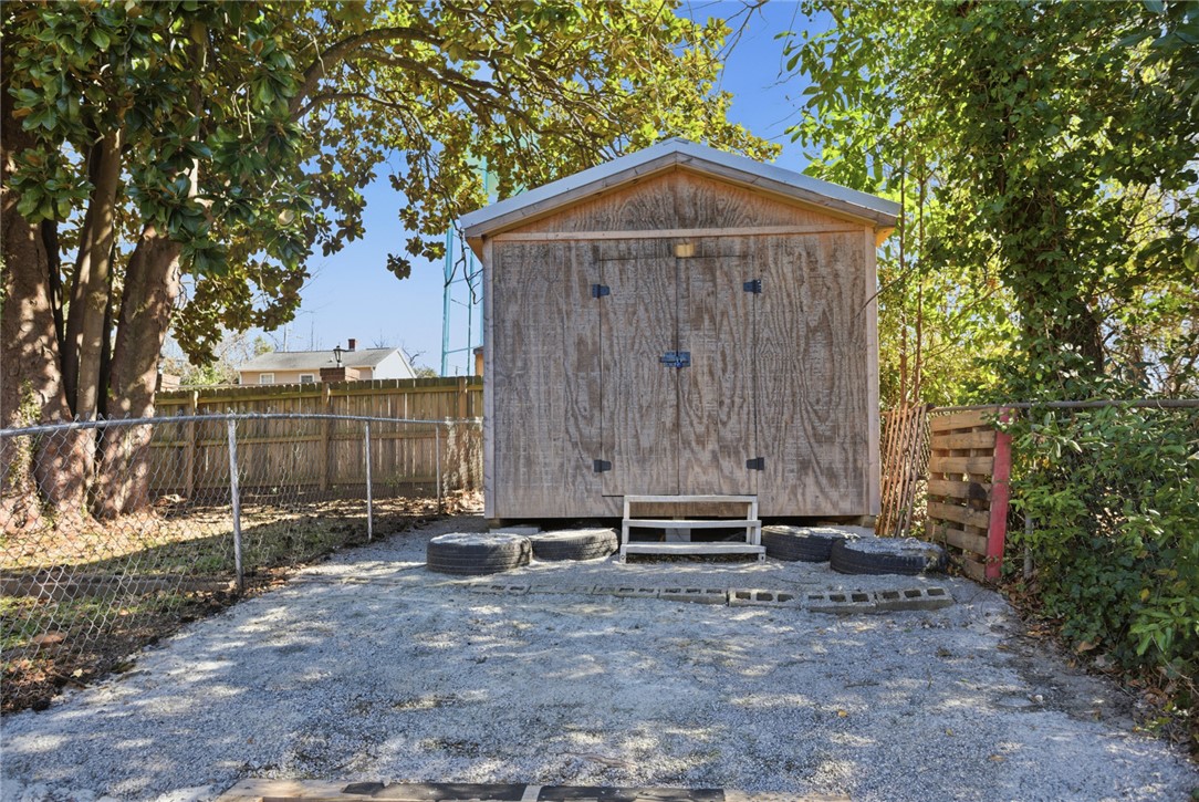 118 North 4th Street Easley, SC 29640 - Photo 13 of 14 This wooden shed offers versatile storage for outdoor essentials, complementing the natural landscape.