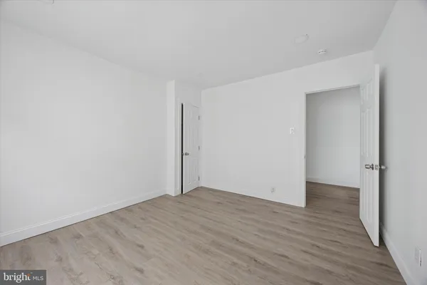 an empty room with wooden floor