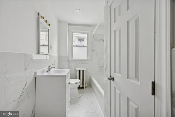 a bathroom with sink a toilet and a mirror