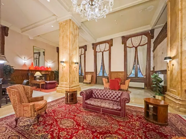 a living room filled with furniture and a chandelier