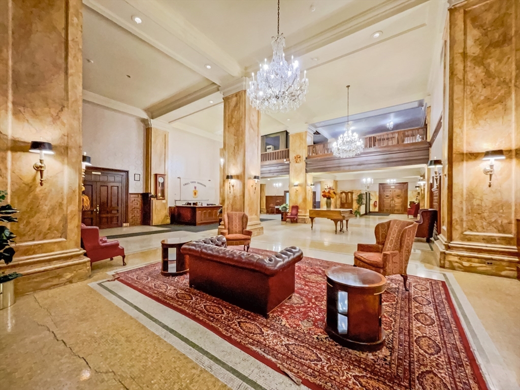 140 Chestnut Street, Unit 204 Springfield, MA 01103 - Photo 12 of 15 a living room with patio furniture and a chandelier