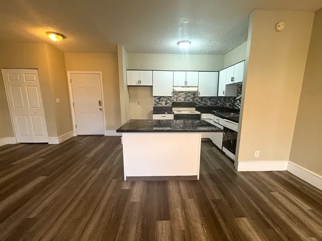 a kitchen with a sink and stove top oven