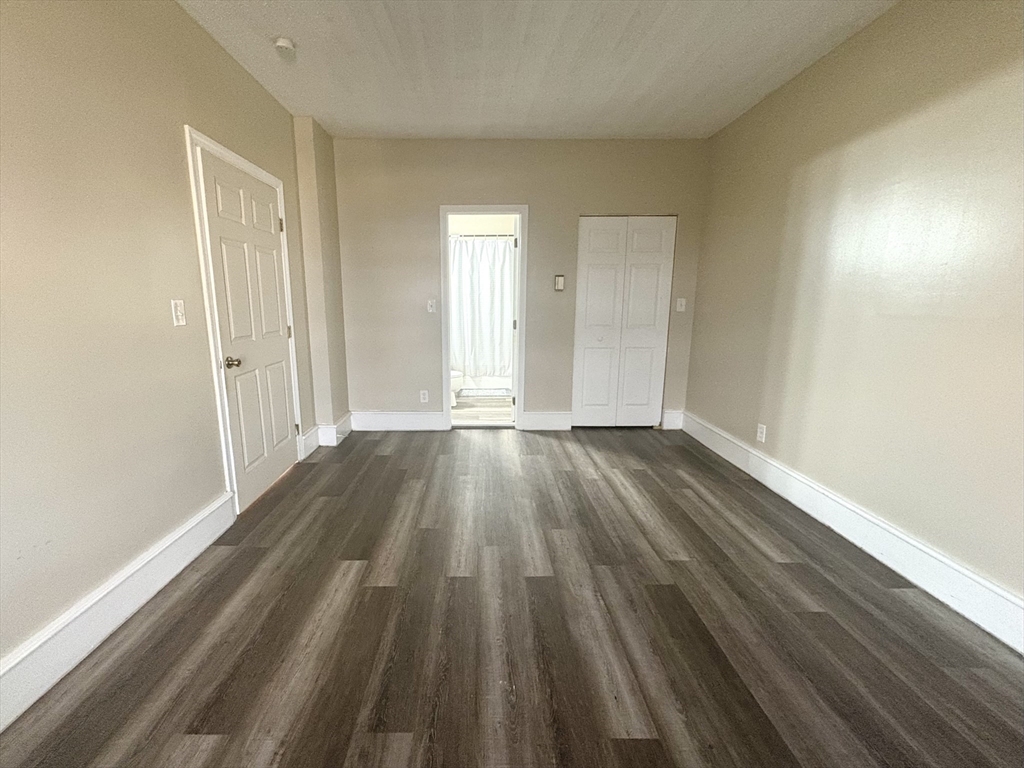 140 Chestnut Street, Unit 204 Springfield, MA 01103 - Photo 7 of 15 a view of a room with wooden floor and window