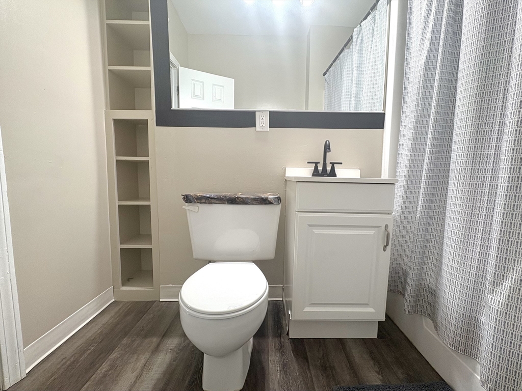 140 Chestnut Street, Unit 204 Springfield, MA 01103 - Photo 9 of 15 a bathroom with a toilet a sink and a window