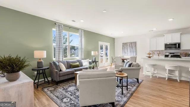 a living room with furniture wooden floor and a potted plant
