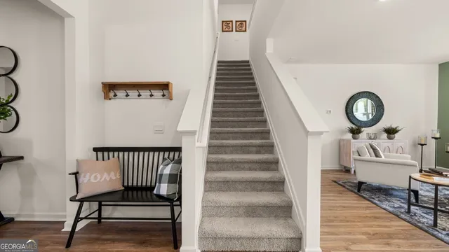 a view of entryway and hall with wooden floor