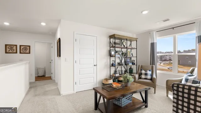 a living room with furniture and a floor to ceiling window