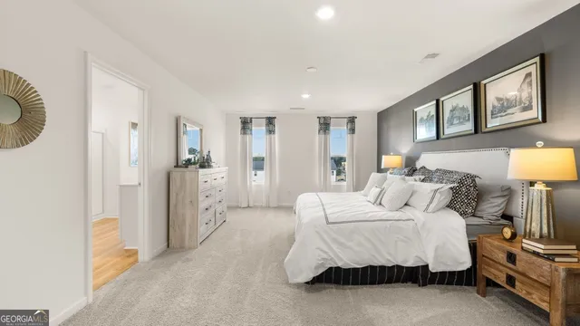 a bedroom with a bed a mirror and lamp