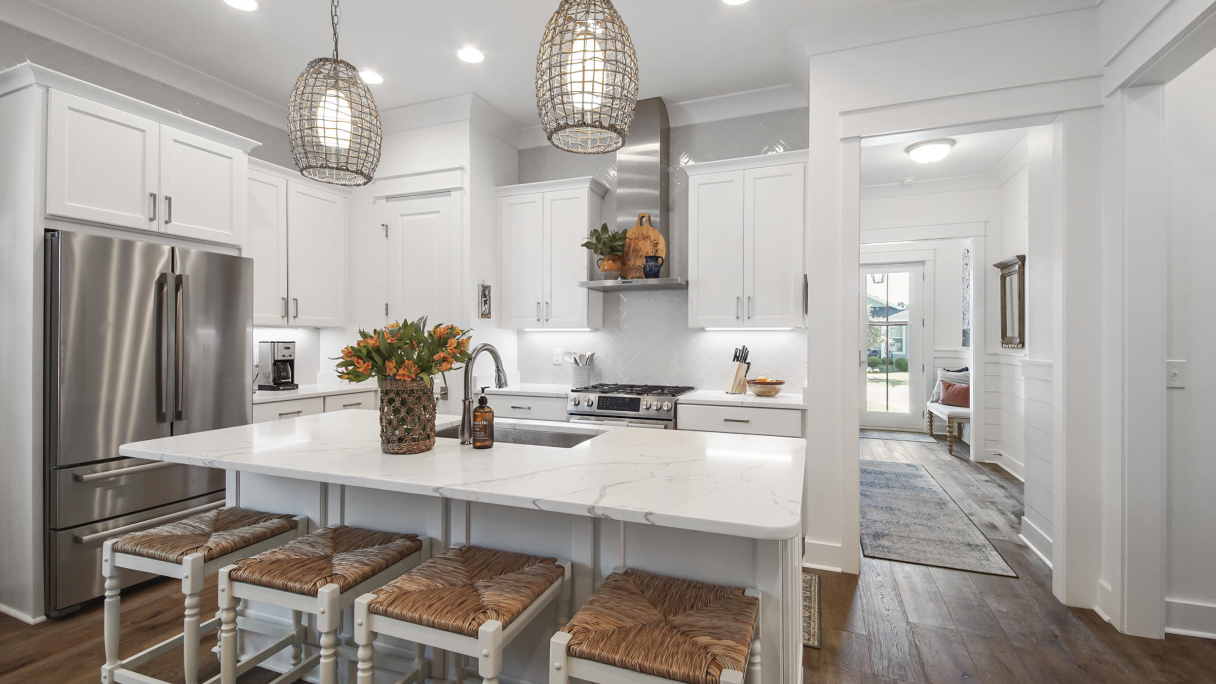 111 Firefly Way Watersound, FL 32461 - Photo 13 of 54 a kitchen with granite countertop a table chairs stove and refrigerator