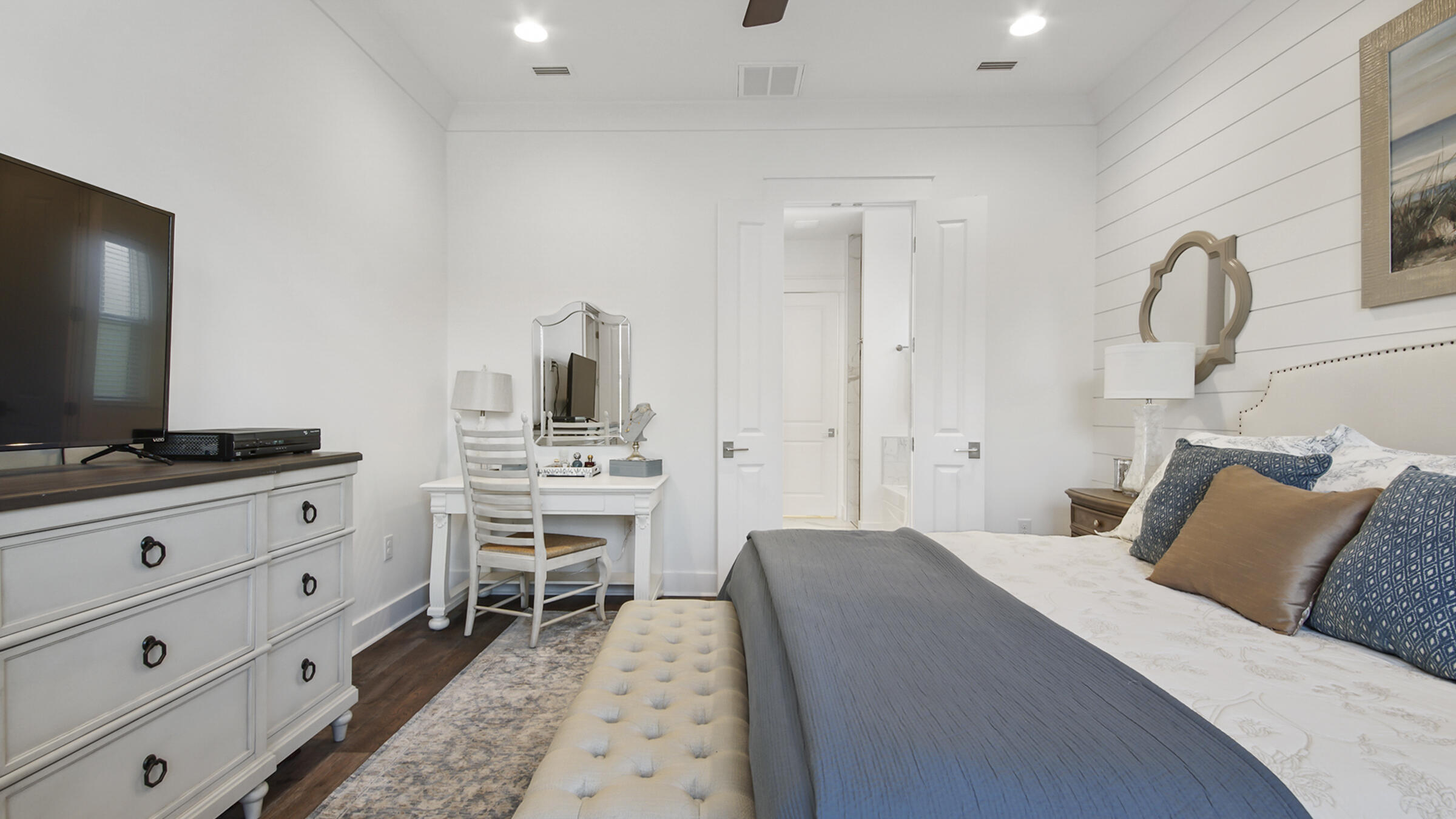 111 Firefly Way Watersound, FL 32461 - Photo 21 of 54 a bedroom with a bed and a flat screen tv