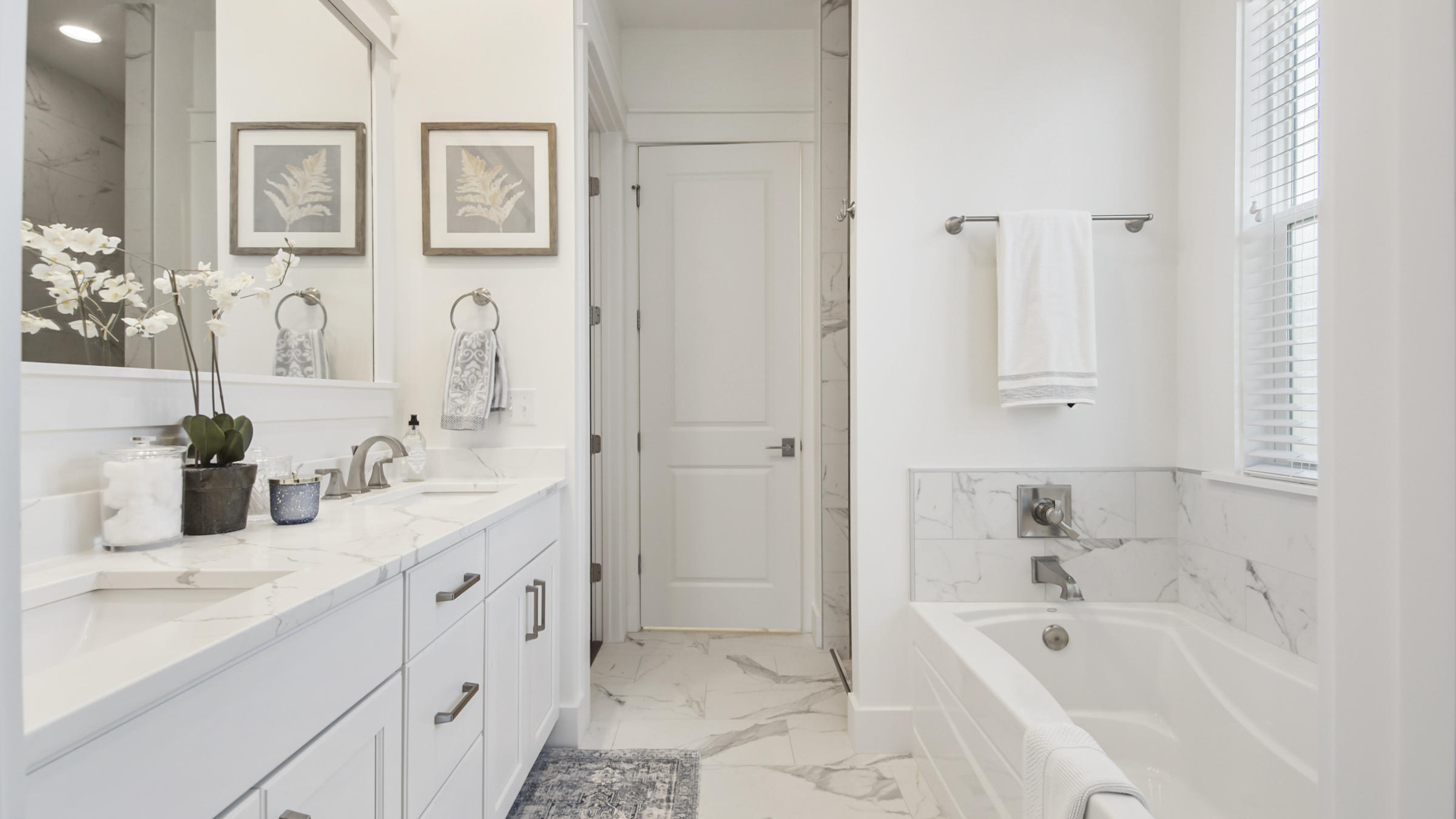 111 Firefly Way Watersound, FL 32461 - Photo 23 of 54 a bathroom with a tub sink and mirror