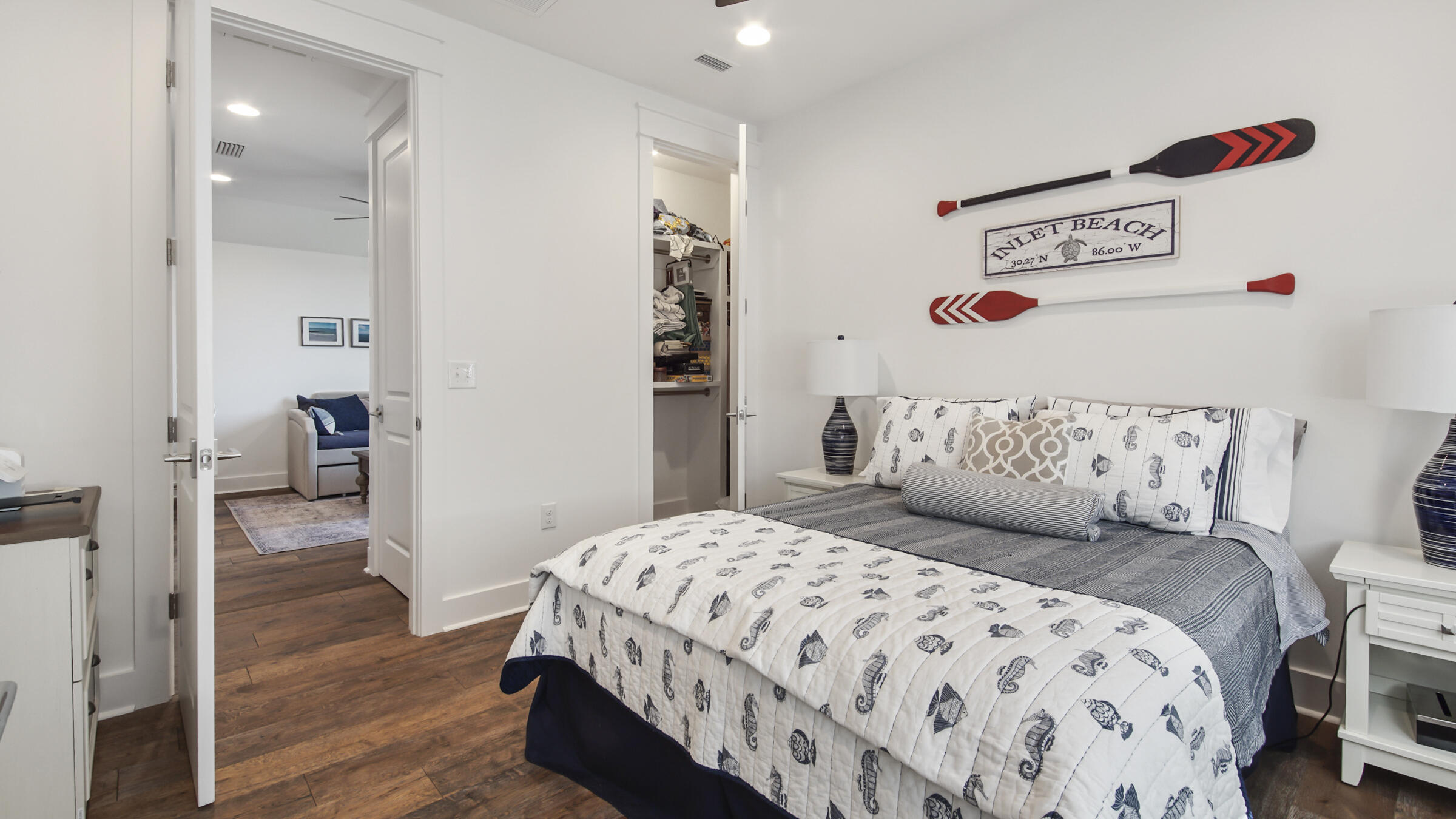 111 Firefly Way Watersound, FL 32461 - Photo 35 of 54 a bedroom with a bed and wooden floor