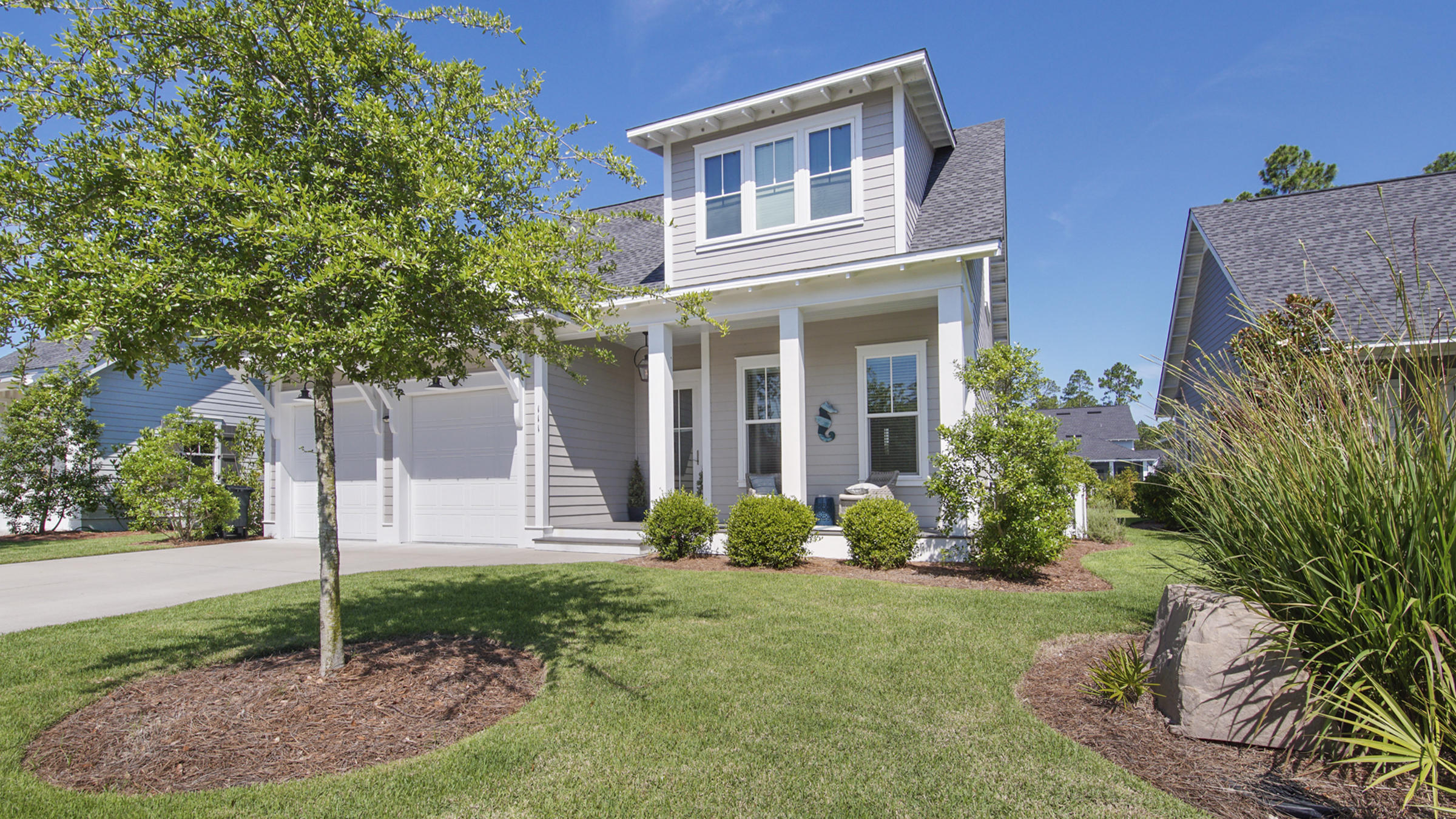 111 Firefly Way Watersound, FL 32461 - Photo 44 of 54 a front view of a house with garden