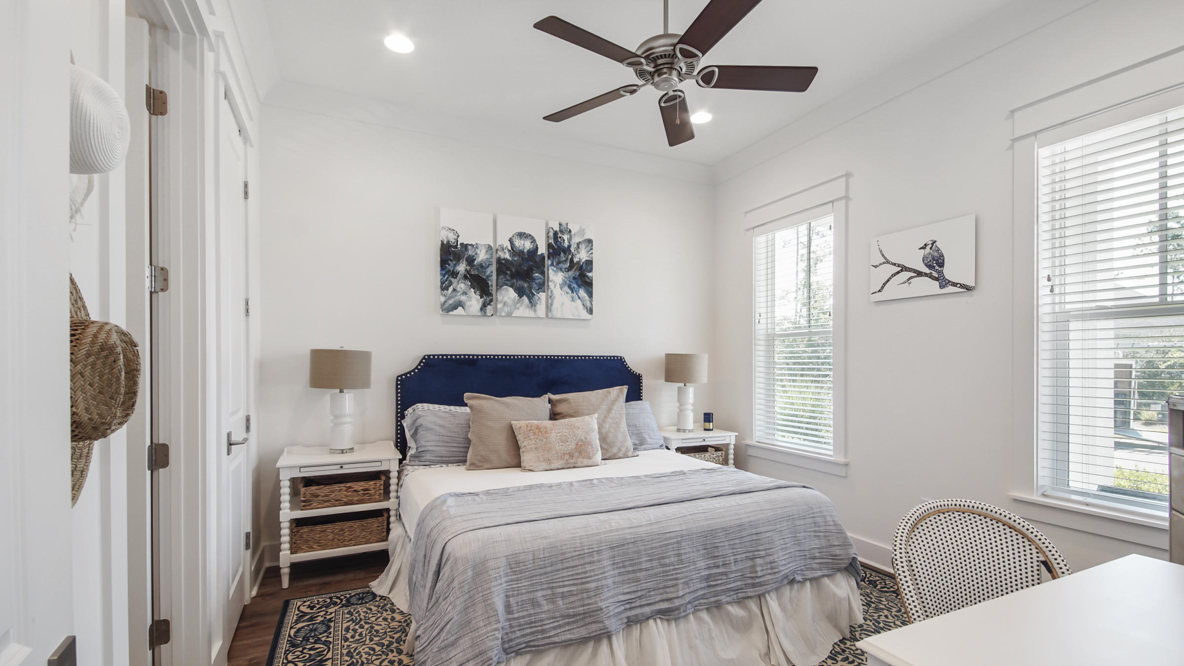 111 Firefly Way Watersound, FL 32461 - Photo 6 of 54 a bedroom with a large bed and a chandelier