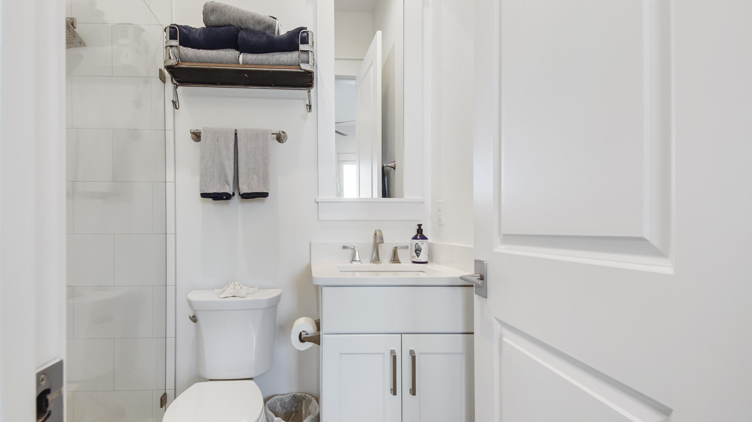 111 Firefly Way Watersound, FL 32461 - Photo 9 of 54 a bathroom with a sink toilet and vanity