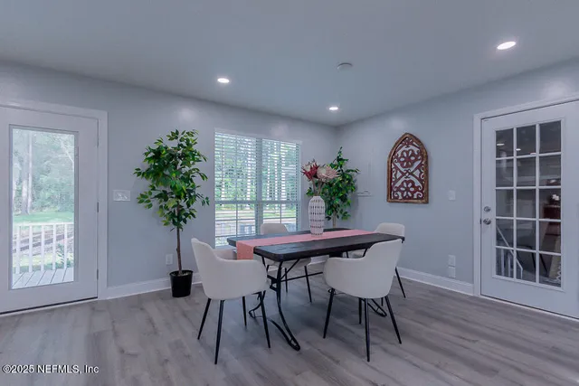 a very nice looking dining room with a large window