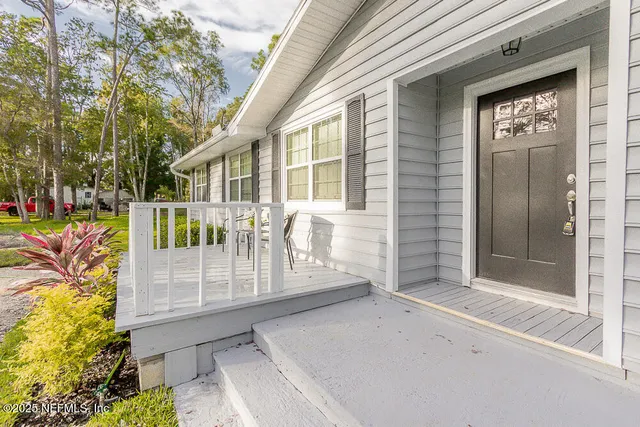 a view of a workspace with furniture and a potted plant