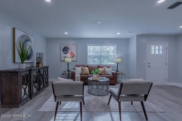 a large kitchen with a wooden floor and cabinets