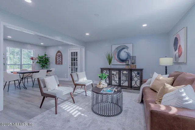 a kitchen with granite countertop white cabinets white appliances and a sink