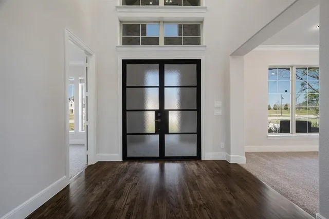 a view of a windows and an entryway with wooden floor