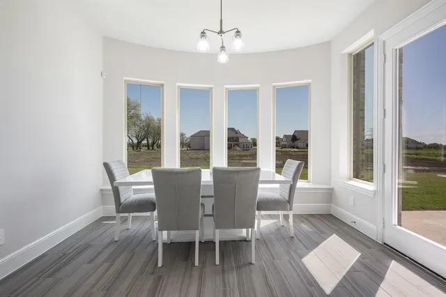 a large kitchen with granite countertop a large counter top a sink stainless steel appliances and cabinets