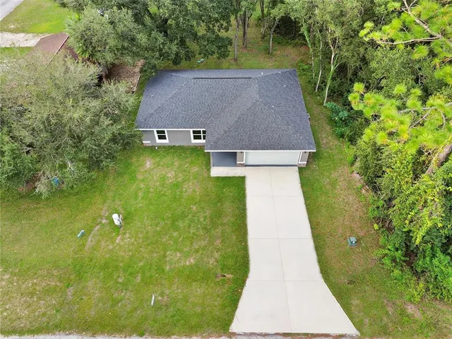 a aerial view of a house with a yard