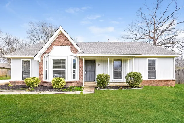 a front view of a house with a garden