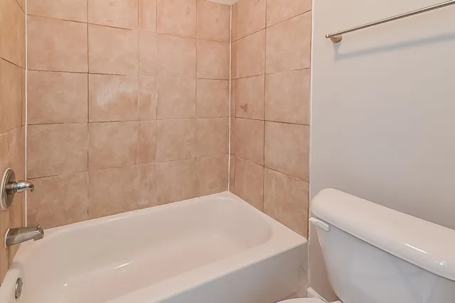 a bathroom with a bathtub and a toilet