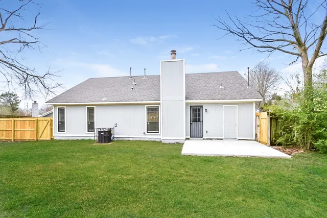 a front view of a house with a yard and sitting area