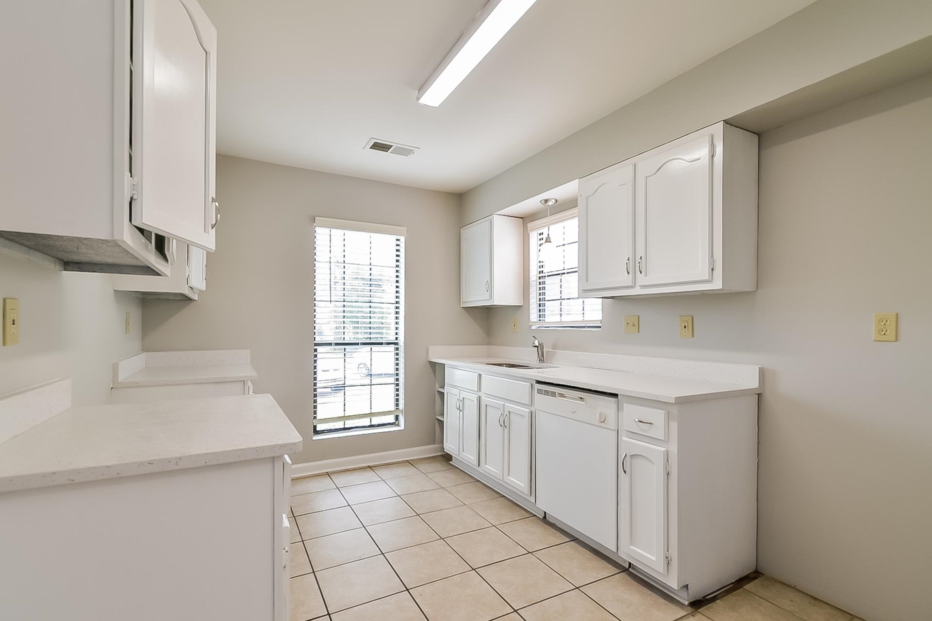 3890 Birchshade Cove Memphis, TN 38115 - Photo 7 of 16 a kitchen with a sink cabinets appliances and a window