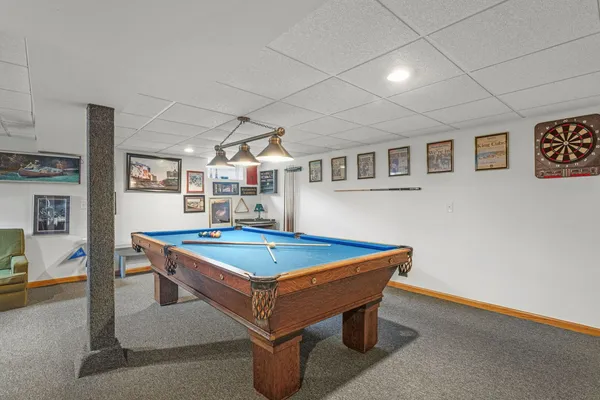 a room with pool table and windows