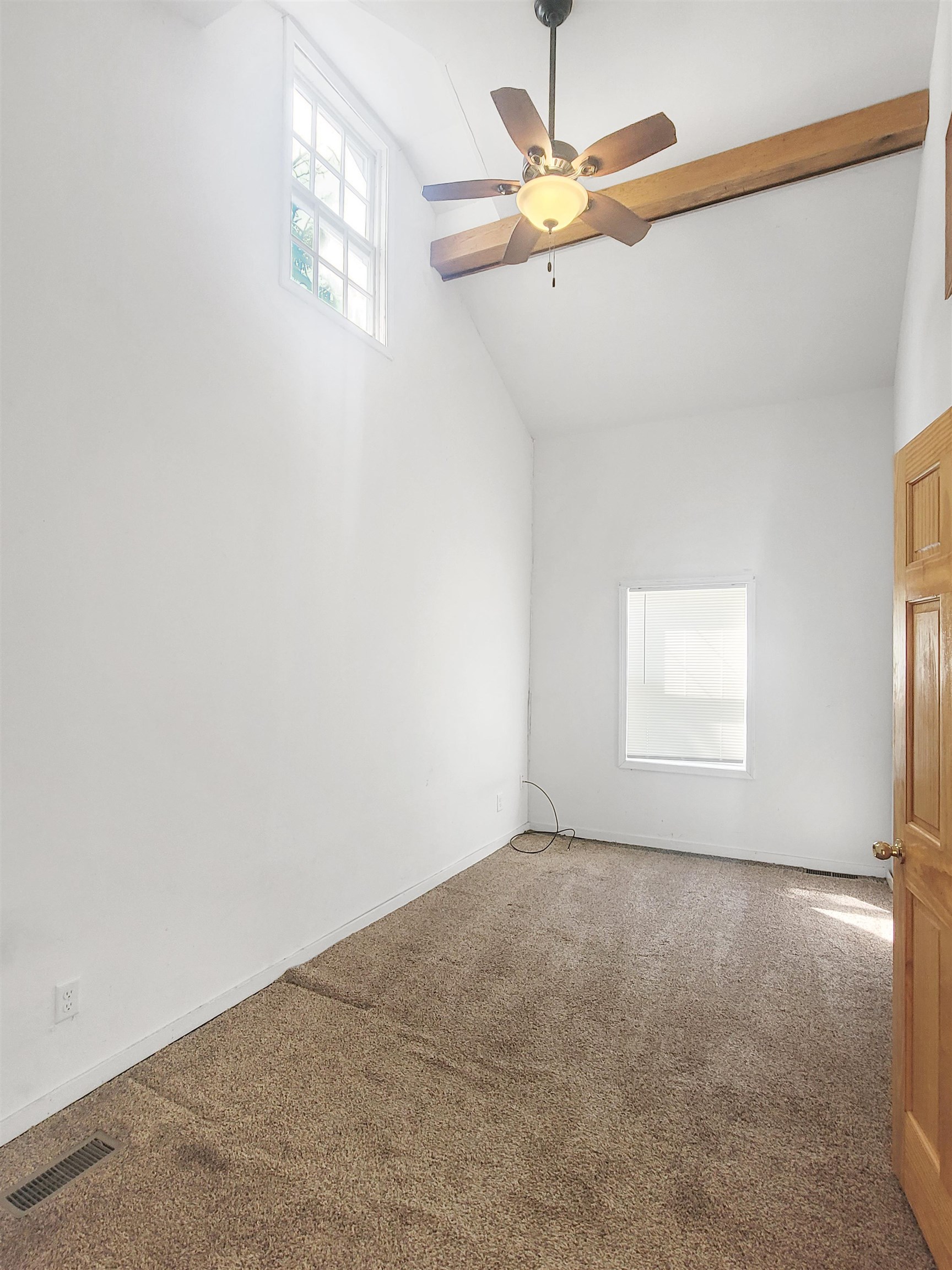610 South High Street Galena, IL 61036 - Photo 12 of 22 an empty room with a window and a fan