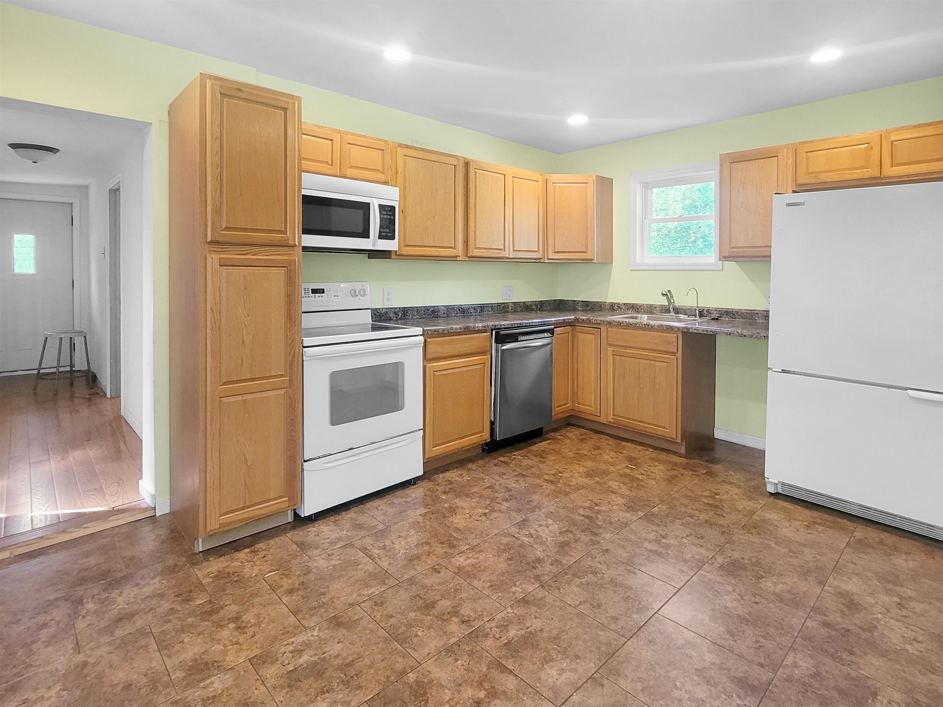 610 South High Street Galena, IL 61036 - Photo 6 of 22 a kitchen with granite countertop stainless steel appliances and refrigerator