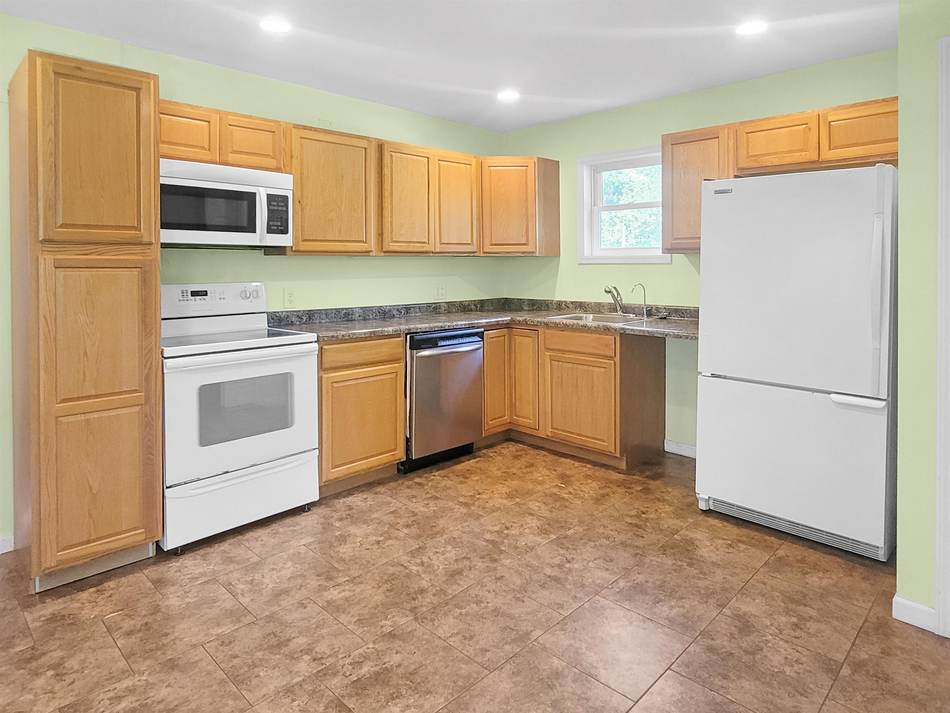 610 South High Street Galena, IL 61036 - Photo 7 of 22 a kitchen with granite countertop cabinets stainless steel appliances and a refrigerator