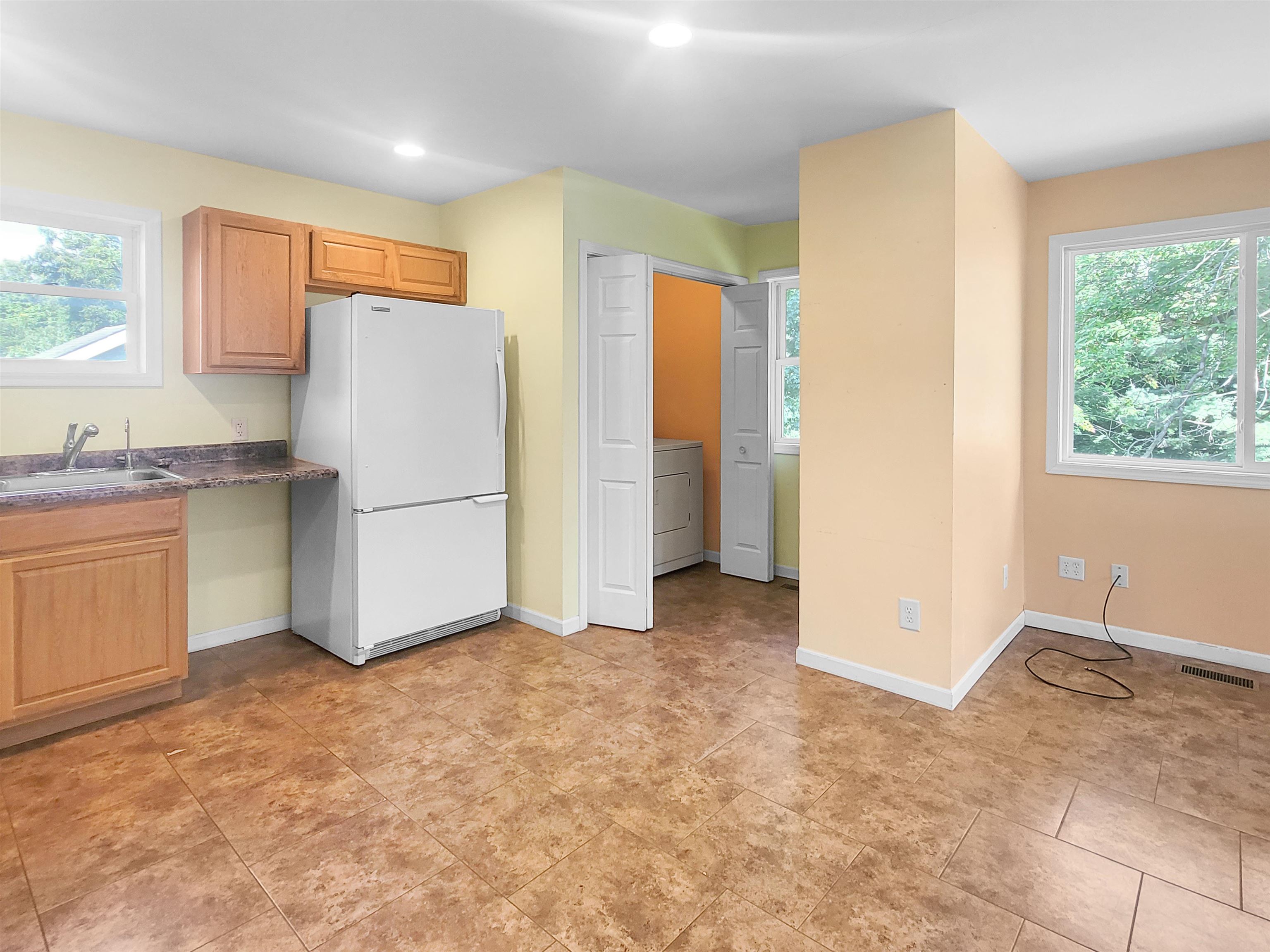 610 South High Street Galena, IL 61036 - Photo 8 of 22 a view of kitchen with refrigerator cabinets and a window