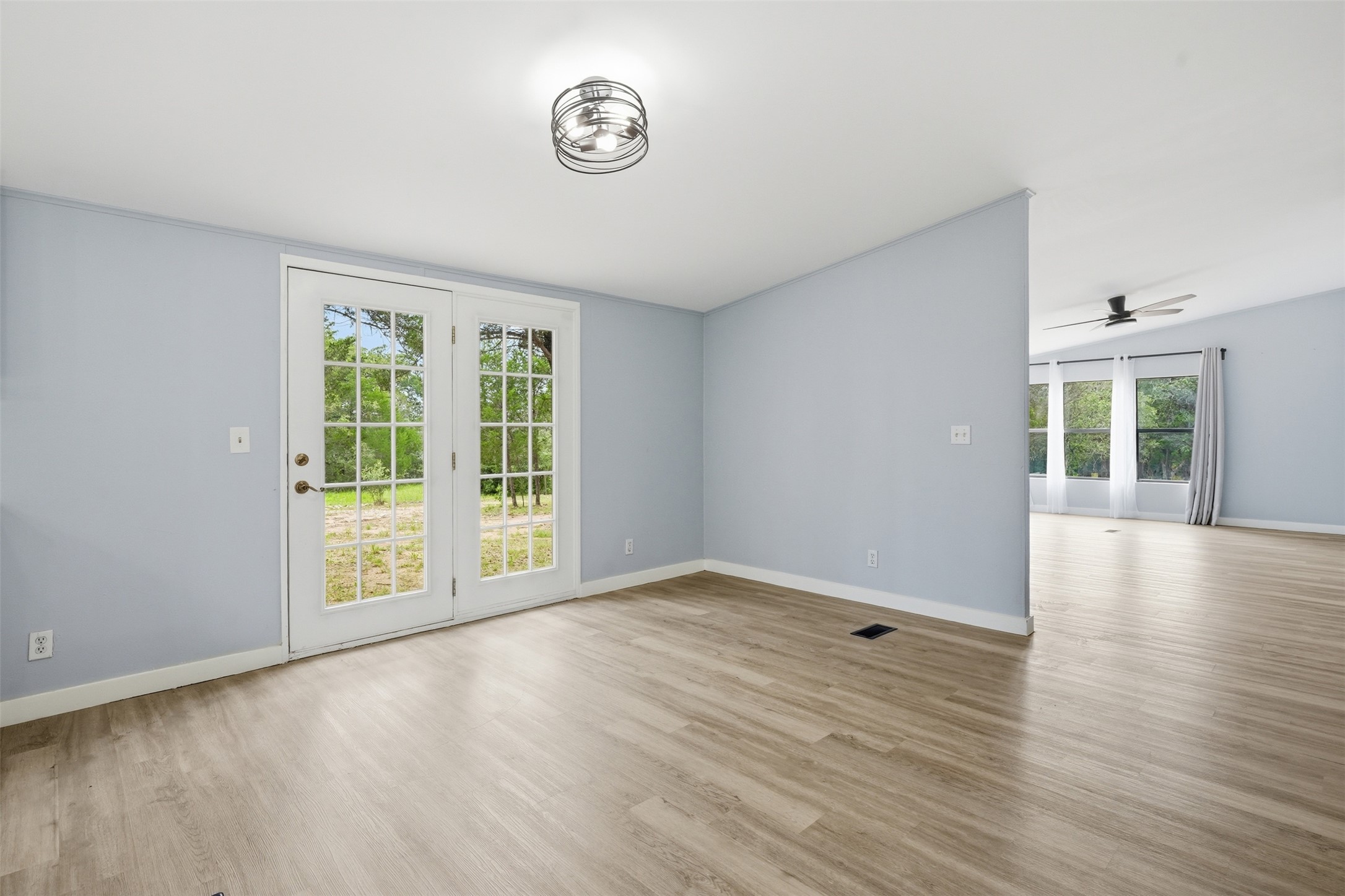 154 Antioch Road Smithville, TX 78957 - Photo 8 of 32 French doors open to outdoor serenity, connecting interior space with the natural landscape.