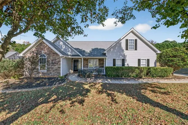 a front view of a house with a garden