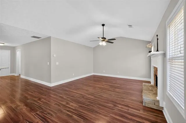 a view of a room with wooden floor and chandelier