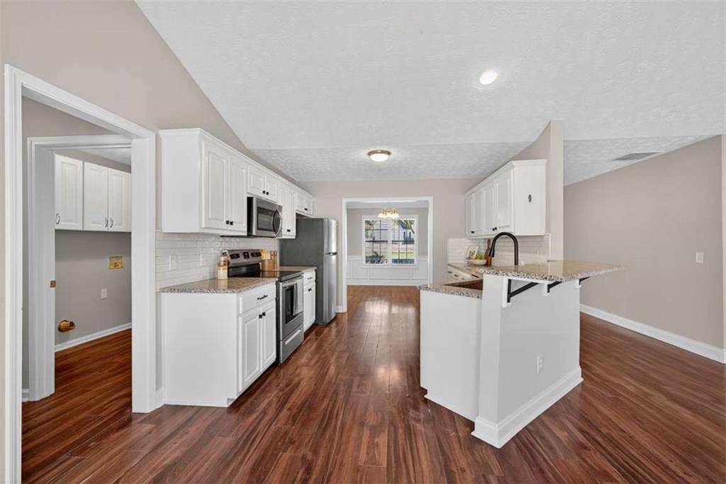 70 Tysor Court Jefferson, GA 30549 - Photo 18 of 50 a kitchen with refrigerator cabinets and wooden floor