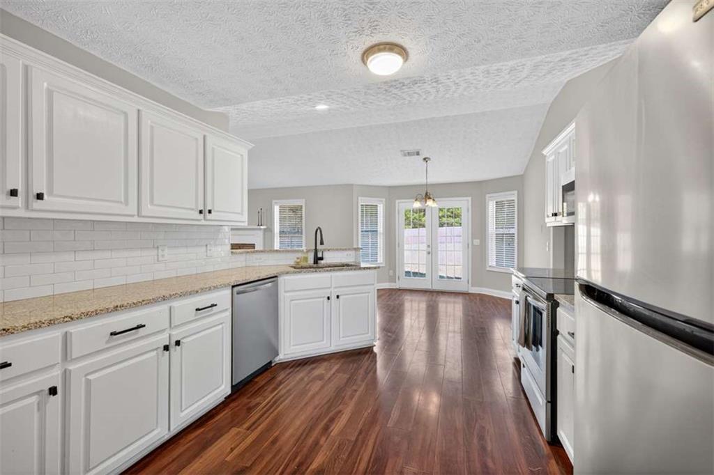 70 Tysor Court Jefferson, GA 30549 - Photo 24 of 50 a large white kitchen with sink and cabinets