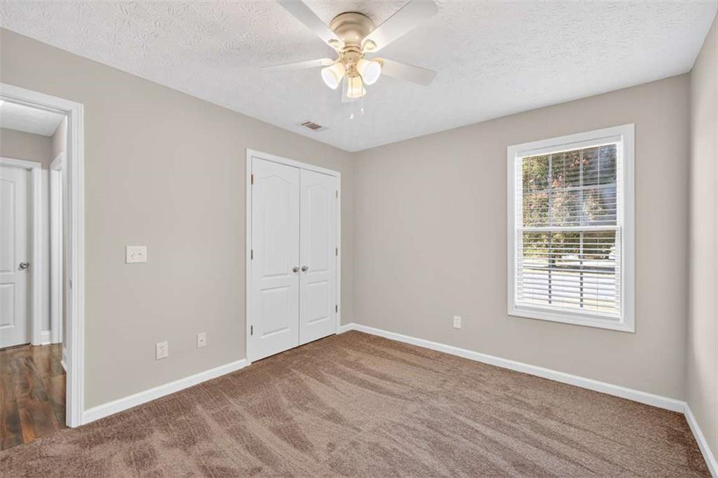 70 Tysor Court Jefferson, GA 30549 - Photo 36 of 50 a view of an empty room with a window and a ceiling fan