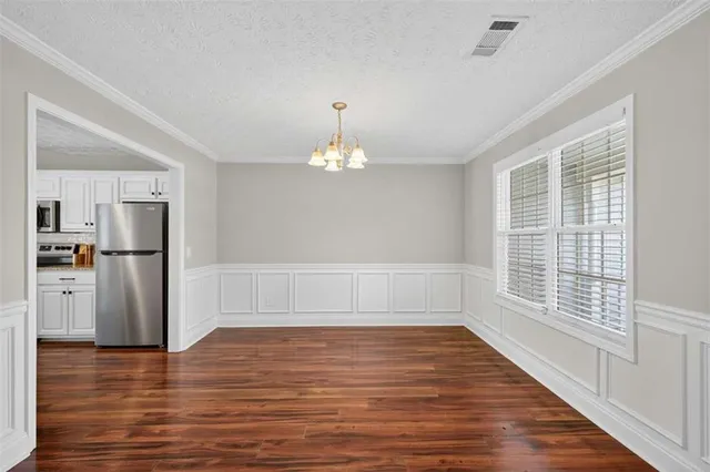 a view of a room with wooden floor fireplace and windows