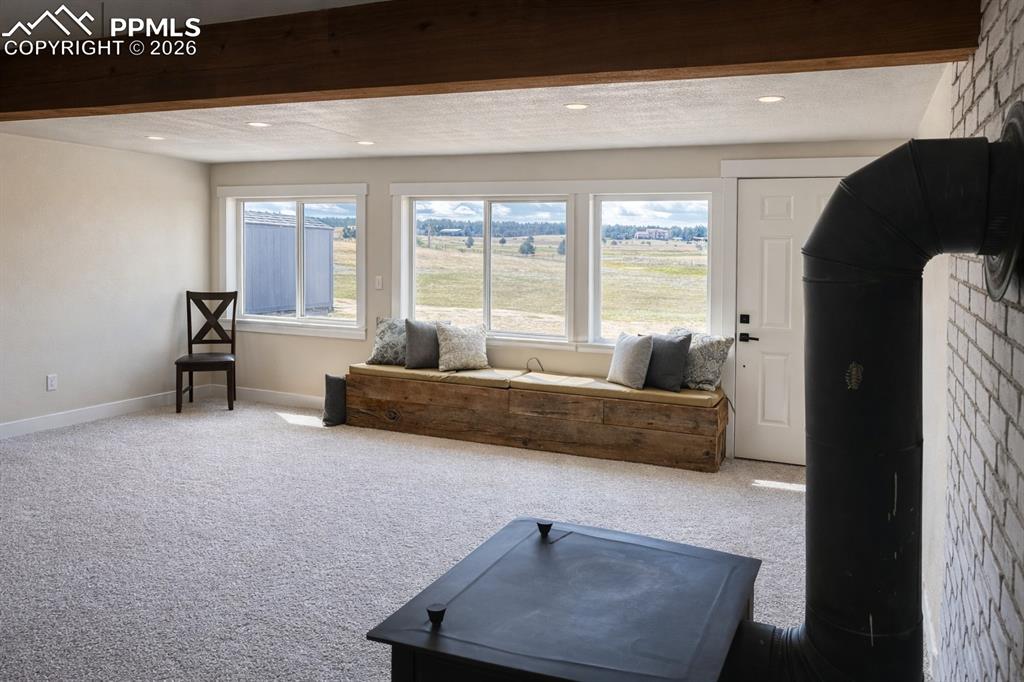 12285 Old Barn Road Elbert, CO 80106 - Photo 24 of 39 a living room with furniture and a large window