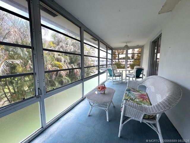2929 Southeast Ocean Boulevard, Unit 1306 Stuart, FL 34996 - Photo 11 of 17 a dining room with furniture a chandelier and wooden floor