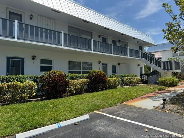 2929 Southeast Ocean Boulevard, Unit 1306 Stuart, FL 34996 - Photo 15 of 17 a front view of a building with a garden
